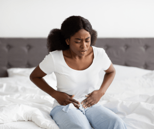 Woman holding Stomach -  Failed IVF - Fertitude